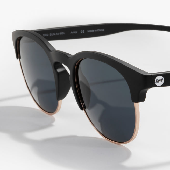 Black sunglasses with dark lenses on a white background