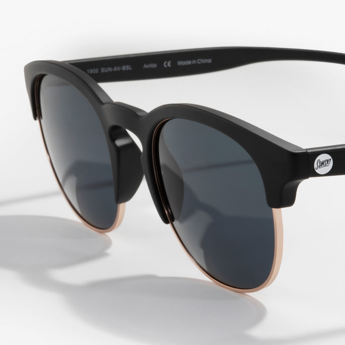 Black sunglasses with dark lenses on a white background