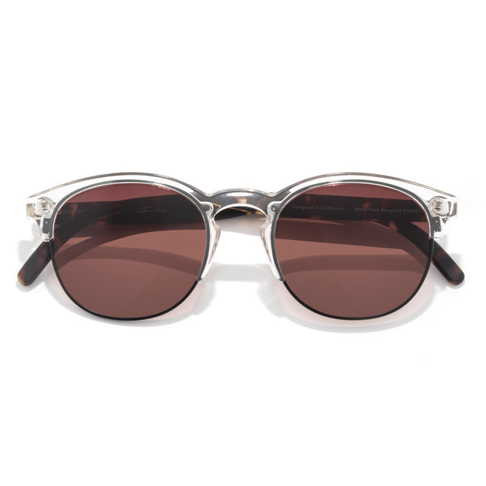 Round sunglasses with brown lenses and silver frame on a white background