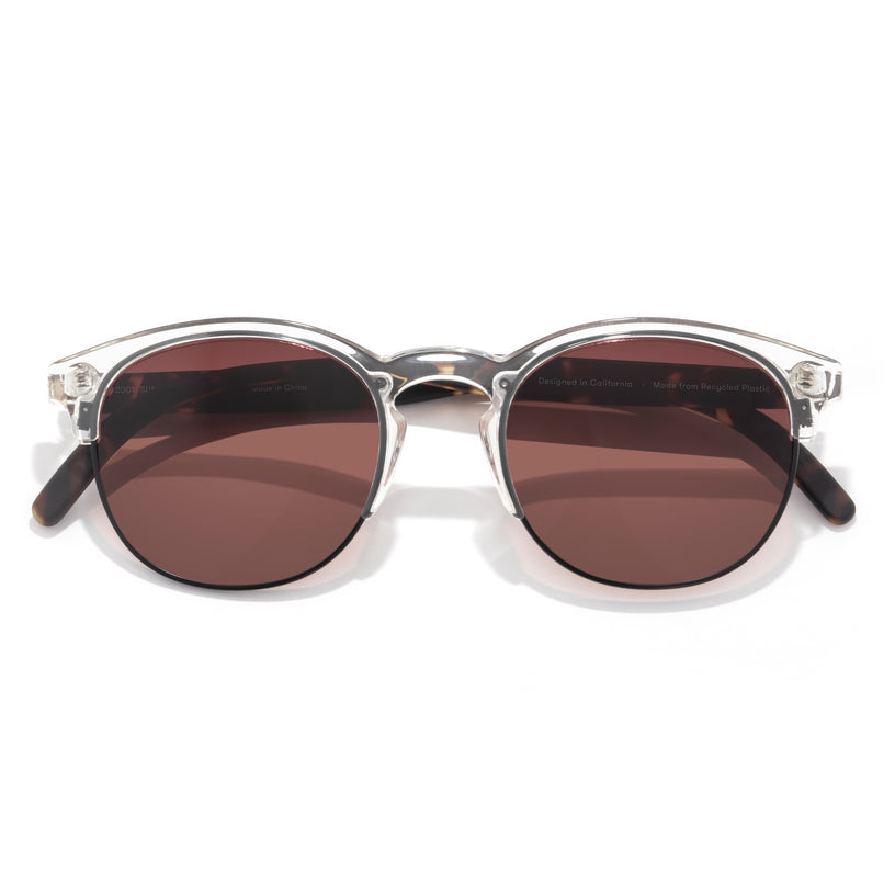 Round sunglasses with brown lenses and silver frame on a white background