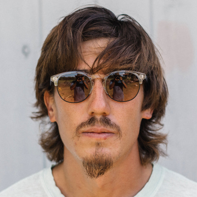 Man wearing sunglasses with a neutral background
