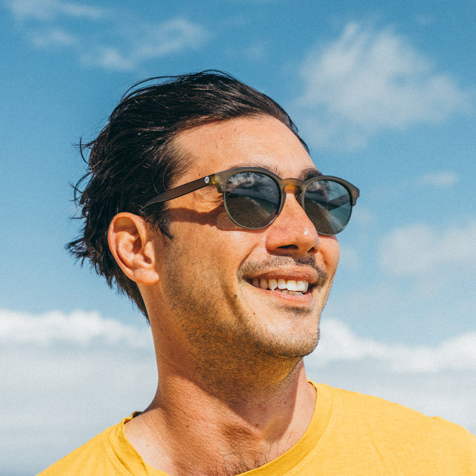 Man wearing sunglasses with a blue sky background