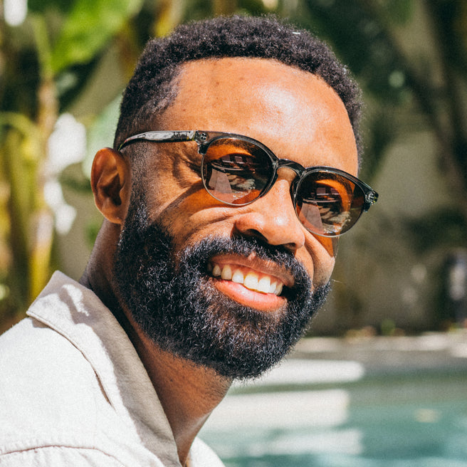 tortoise sunglasses on a man at a pool