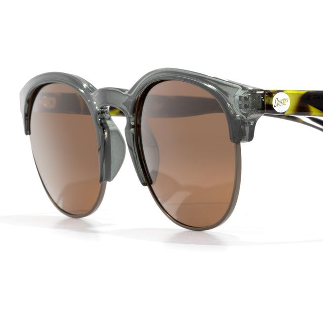 Sunglasses with clear frame and brown lenses on a white background