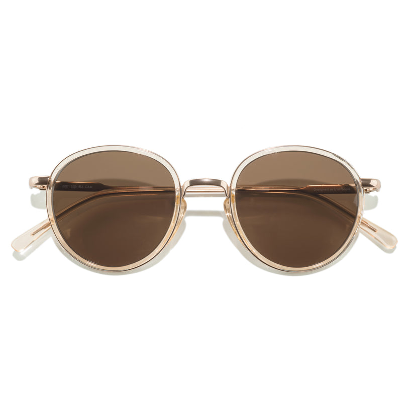 Round sunglasses with gold frame and brown lenses on a white background