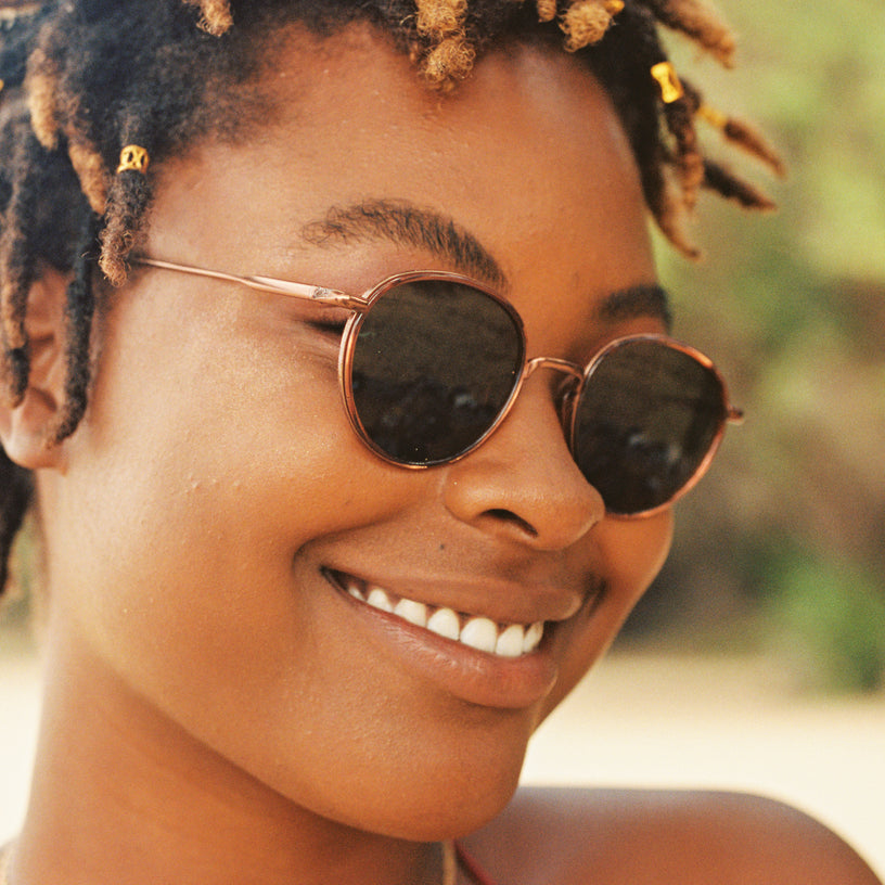 Woman wearing sunglasses with a blurred natural background