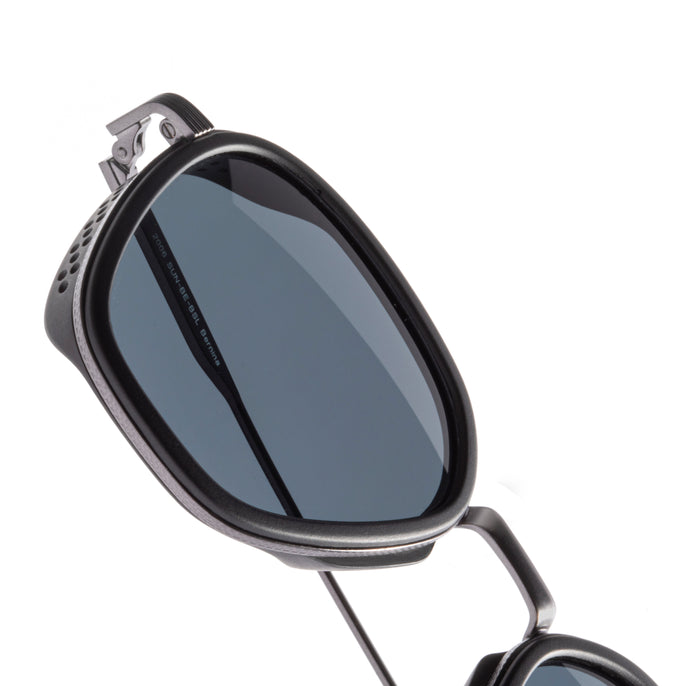 Sunglasses with a reflective lens on a white background