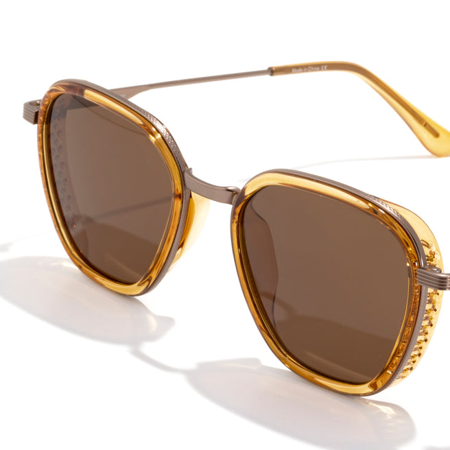 Bernina - Desert Amber - Gold-framed sunglasses with brown lenses on a white background