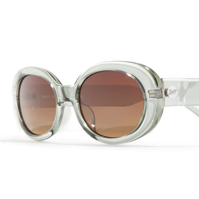 Round sunglasses with clear frame and brown lenses on a white background