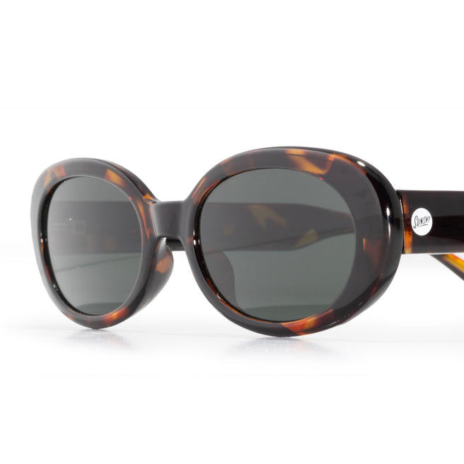 isometric view of tortoise sunglasses with green lens