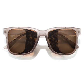Sunglasses with brown lenses and beige frame on a white background
