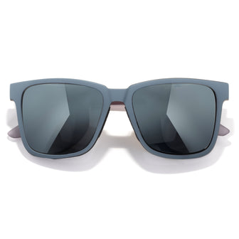 Sunglasses with gray frames and dark lenses on a white background