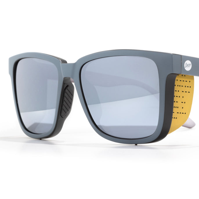 Sunglasses with a yellow strap on a white background