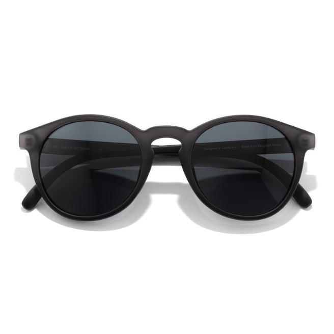 Black sunglasses with dark lenses on a white background