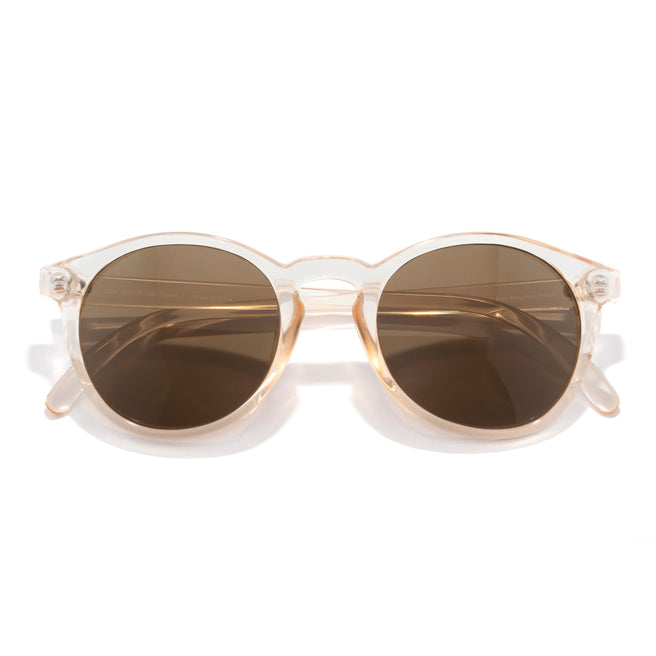 Sunglasses with gold frame and brown lenses on a white background