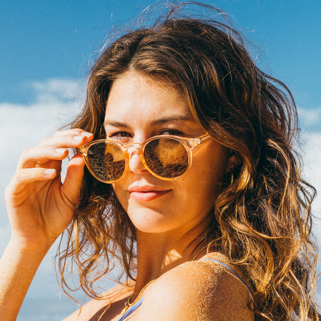 Woman wearing sunglasses with a blue sky background