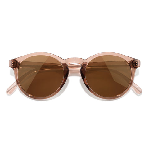Round sunglasses with rose gold frame and brown lenses on a white background