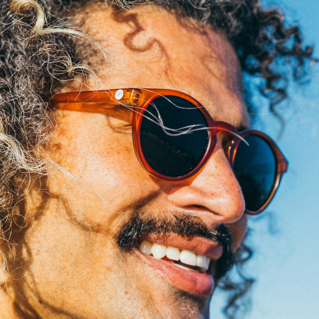 Man wearing sunglasses with a blue sky background
