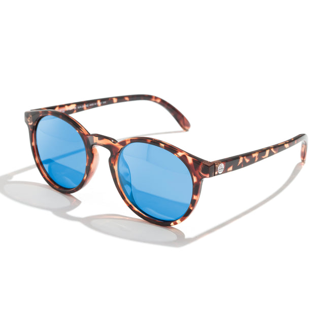 Sunglasses with tortoiseshell frame and blue lenses on a white background