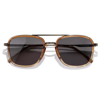 Estero - Horizon Slate - Sunglasses with gold frame and dark lenses on a white background