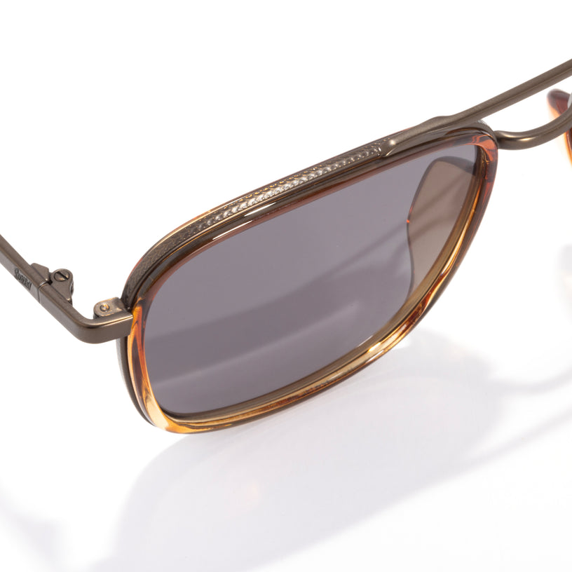 Sunglasses with brown frame and dark lenses on a white background