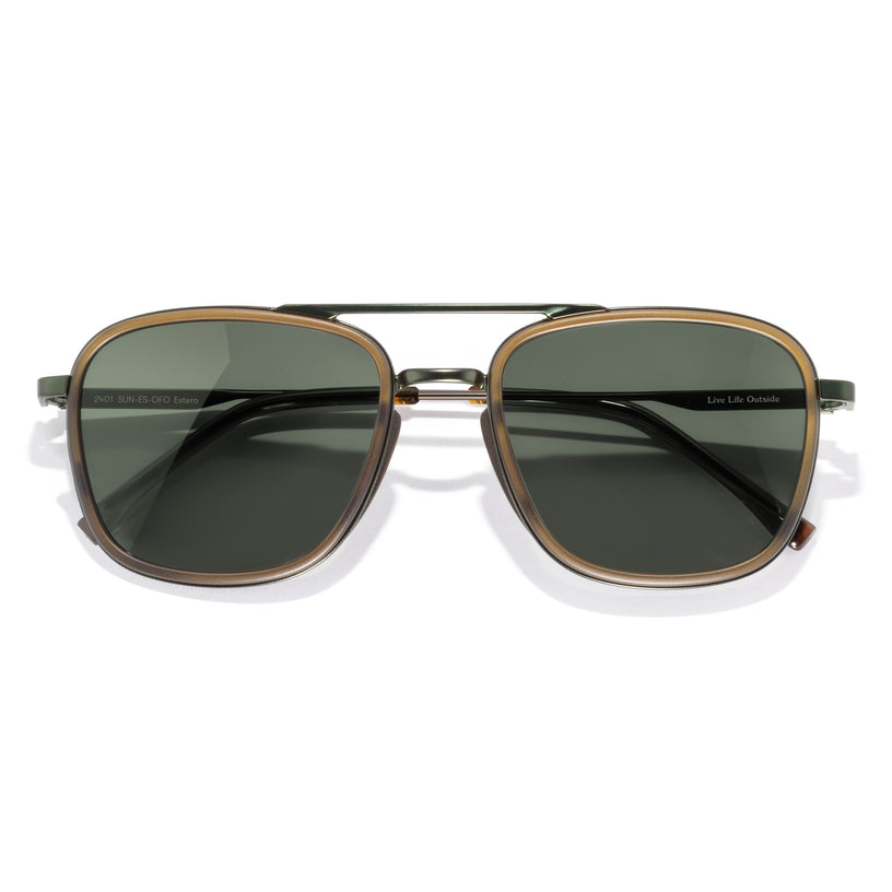 Sunglasses with gold frame and dark lenses on a white background