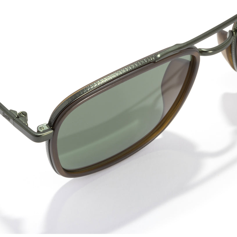 Sunglasses with green lenses and metal frame on a white background