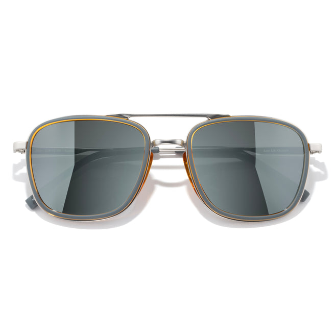Sunglasses with gold frame and dark lenses on a white background