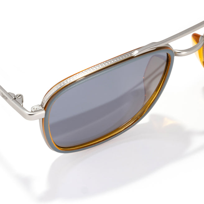 Sunglasses with a reflective lens on a white background