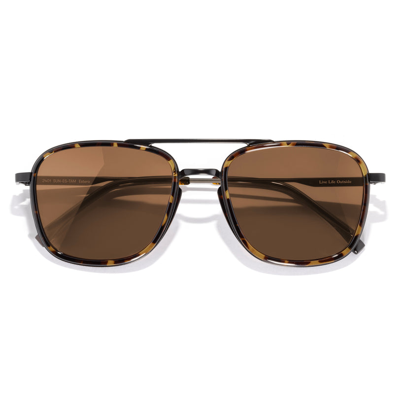 Sunglasses with brown lenses and tortoiseshell frame on a white background
