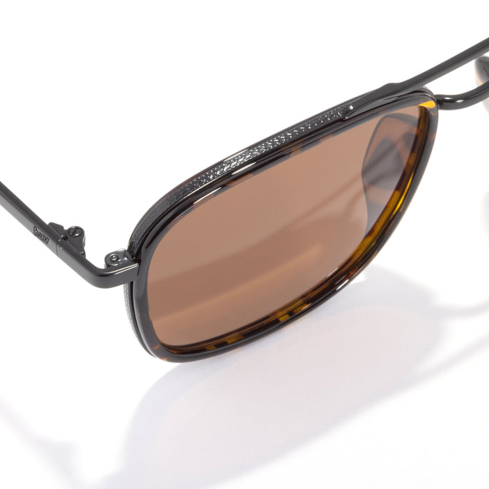 Sunglasses with brown lenses and black frame on a white background