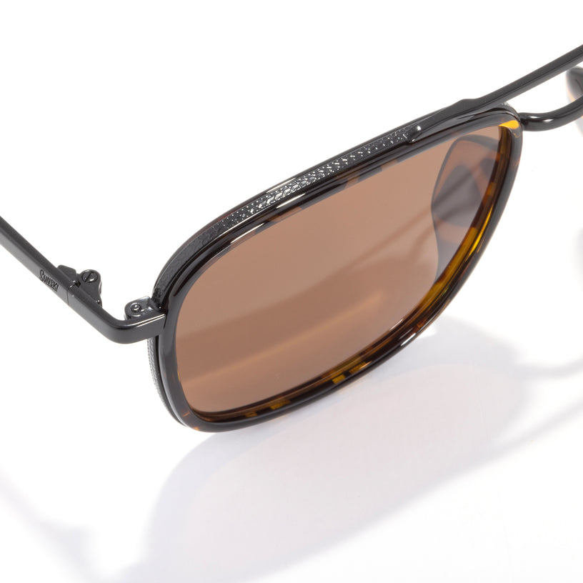 Sunglasses with brown lenses and black frame on a white background