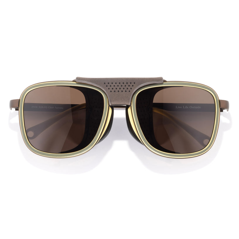 Sunglasses with gold frame and brown lenses on a white background