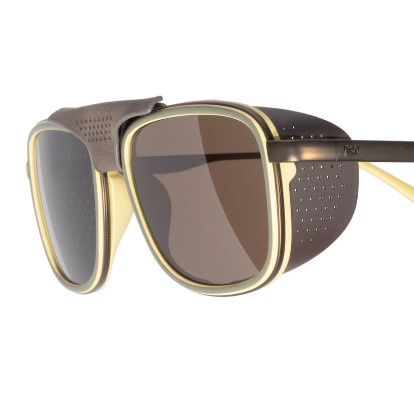 Sunglasses with gold frame and dark lenses on a white background