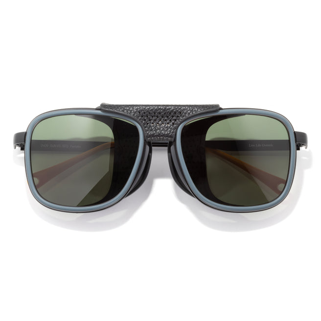 Sunglasses with dark lenses and textured black frame on a white background