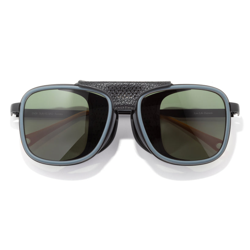 Sunglasses with dark lenses and textured black frame on a white background