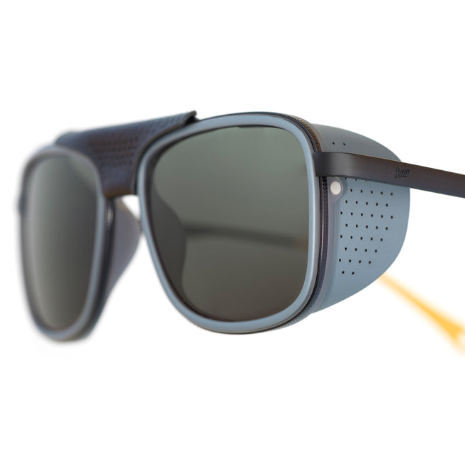 Sunglasses with a gray frame and dark lenses on a white background