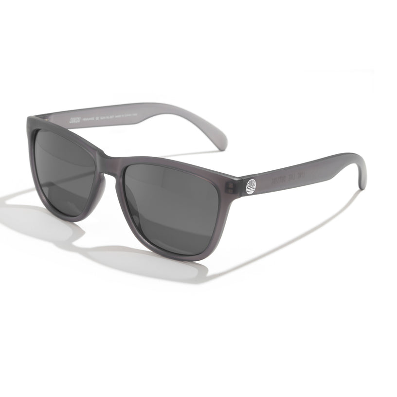 Sunglasses with tortoiseshell frame and dark lenses on a white background