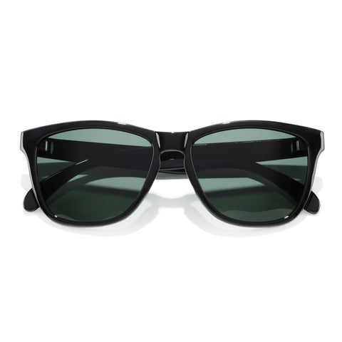 Black sunglasses with green lenses on a white background
