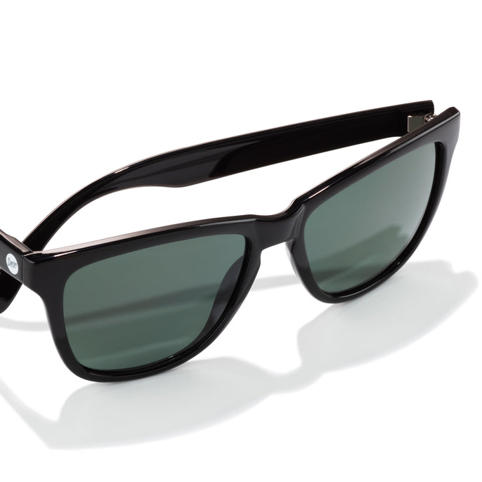Black sunglasses with dark lenses on a white background