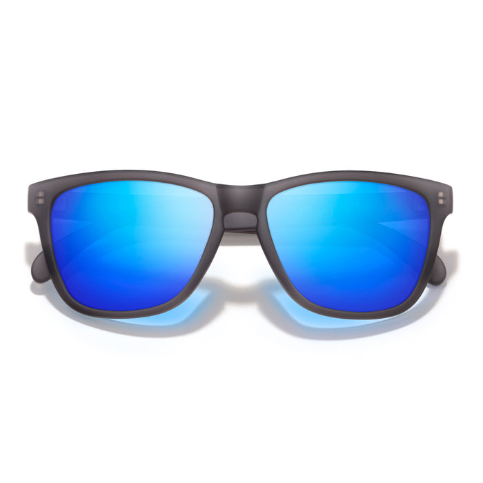 Sunglasses with blue reflective lenses and black frame on a white background