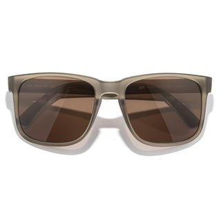 Sunglasses with brown lenses and a beige frame on a white background