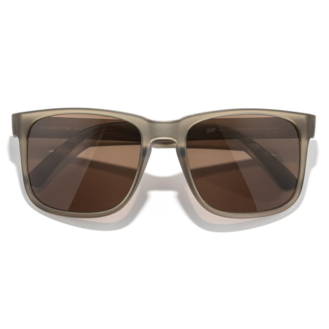 Sunglasses with brown lenses and a beige frame on a white background
