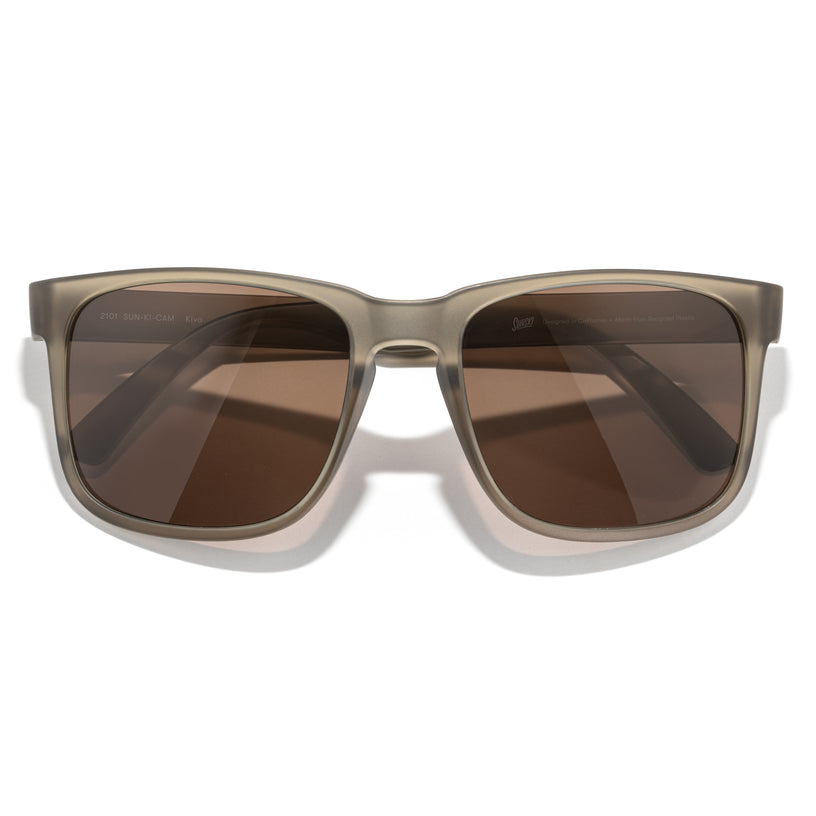 Sunglasses with brown lenses and a beige frame on a white background