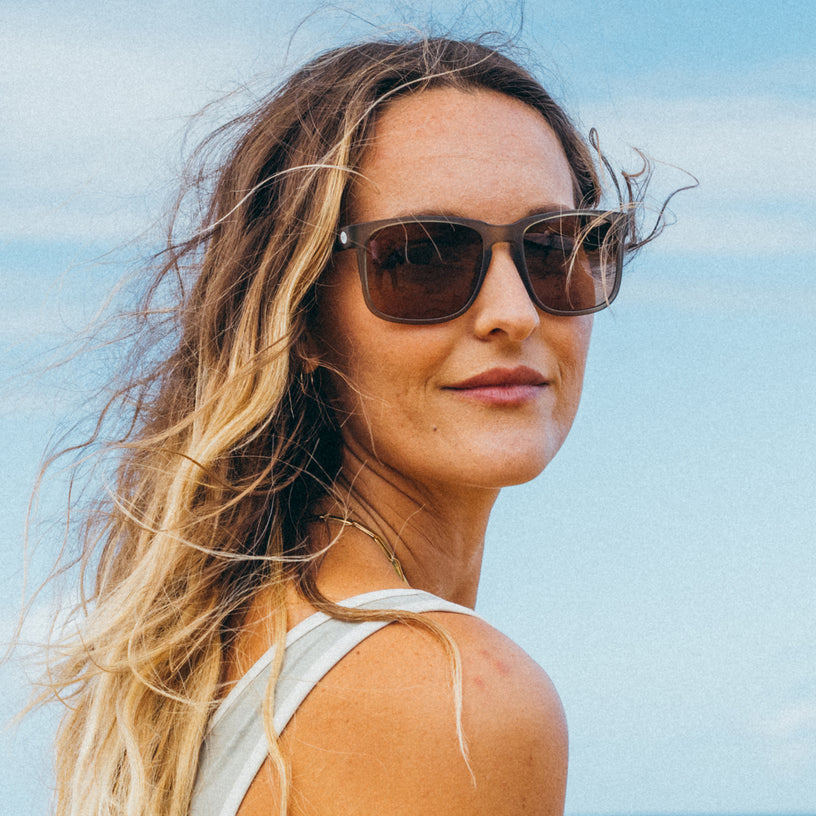 Woman wearing sunglasses with a clear blue sky background