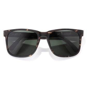 Sunglasses with tortoiseshell frame and dark lenses on a white background