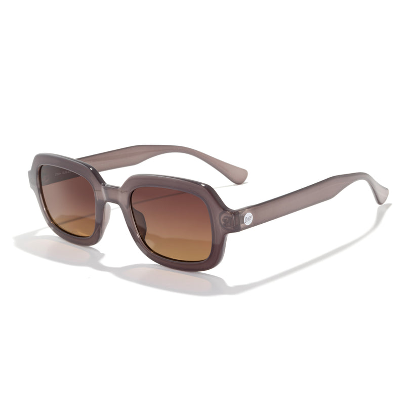 Sunglasses with brown lenses and a clear frame on a white background
