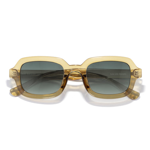 Gold-framed sunglasses with dark lenses on a white background