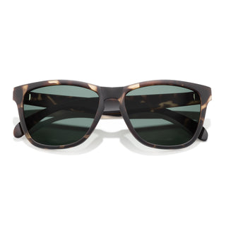 Sunglasses with tortoiseshell frame and dark lenses on a white background