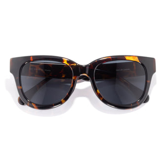 Sunglasses with tortoiseshell frame and dark lenses on a white background